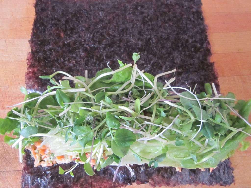 vegetables on nori sheets topped with lettuce and sprouts
