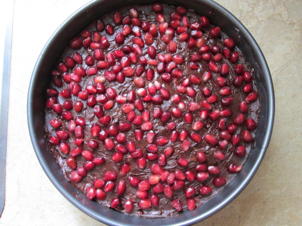 Pomegranate and Chocolate Coconut Cream Cake - cake topped with pomegranate seeds